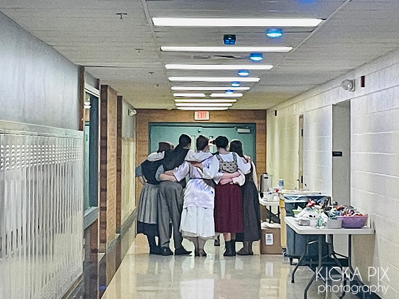 The cast posing for photos backstage